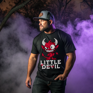Man wearing a black t-shirt with a red devil graphic and 'Little Devil' text, standing against a purple smoke background.